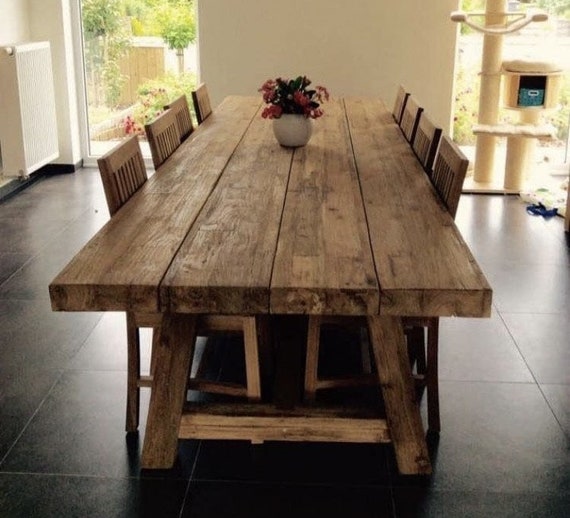 A rustic wooden table set with a vibrant Heirloom Tomato and Basil Tart, showcasing colorful tomatoes and fresh basil.
