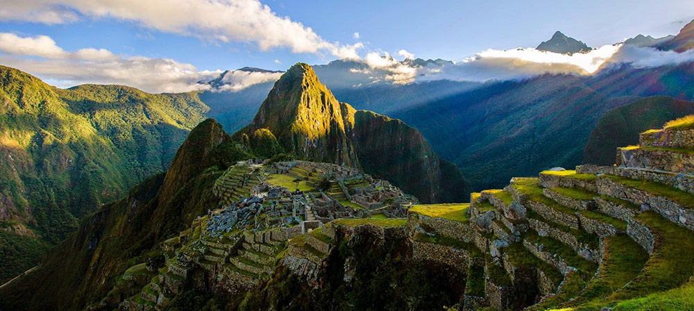 A stunning sunrise view of Machu Picchu from the Sun Gate, captured with a time-lapse effect.
