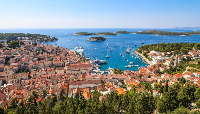 Passengers on a Katarina Line gulet enjoying a meal of Škampi na buzaru while sailing the Adriatic Sea