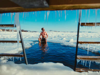 Panoramic view of Banff National Park at sunrise, showcasing the golden light hitting the snow-capped mountains.