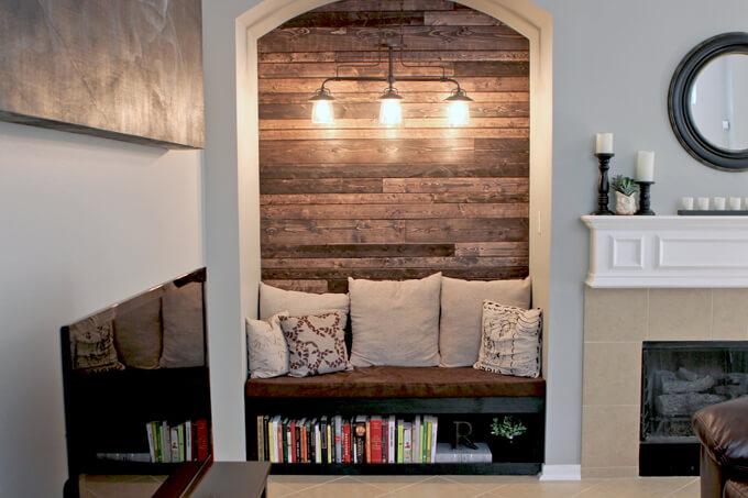 A blanket ladder showcasing a collection of hand-knit throws and scarves in various textures and colors.