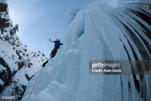 Ice Climber on a Frozen Waterfall