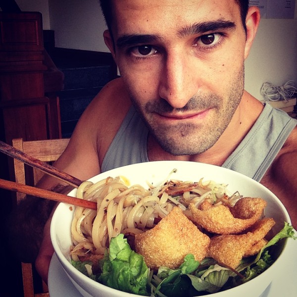 Anya carefully preparing Cao lầu during a cooking class, showcasing the colorful ingredients and the passion for Vietnamese cuisine.