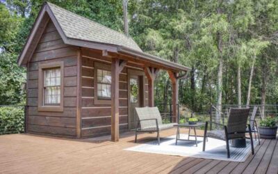 A wood cabin exterior with a wooden porch and log railing.
