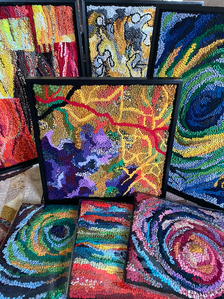 A close-up photograph showcasing a selection of naturally dyed wool, emphasizing the subtle color variations and the tactile quality of the fibers.