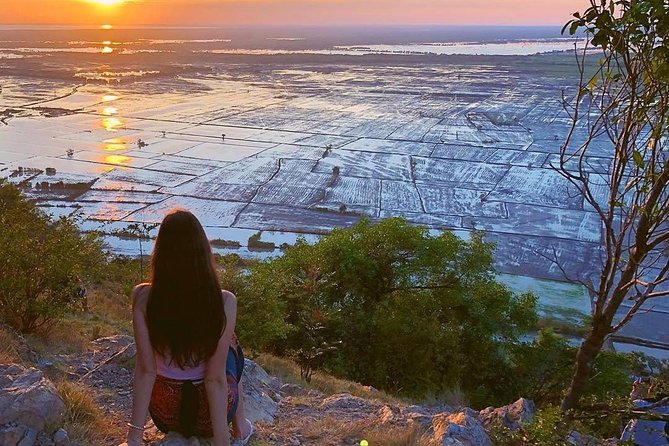 A monk praying at Wat Preah Prom Rath, a colorful temple in Siem Reap.
