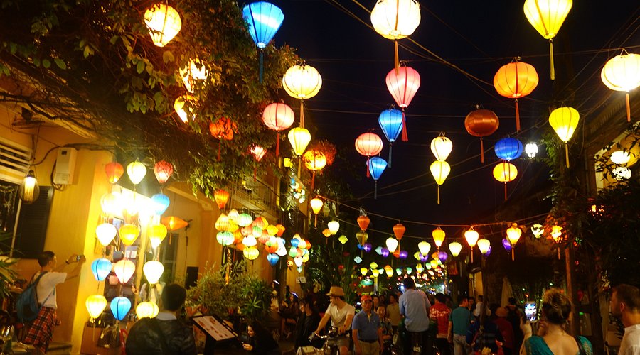 A colorful street scene along the river in Hoi An, Vietnam at night.