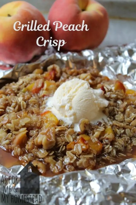 Close-up of a serving of apple crisp with a scoop of melting ice cream on a spoon.