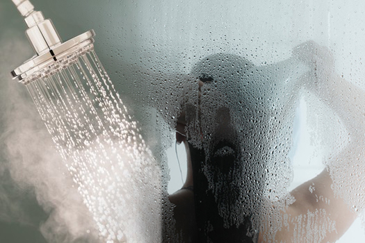 A close-up shot of baking soda being poured into a drain, slightly blurred to emphasize movement, in soft, natural lighting. Use a macro lens for detail.