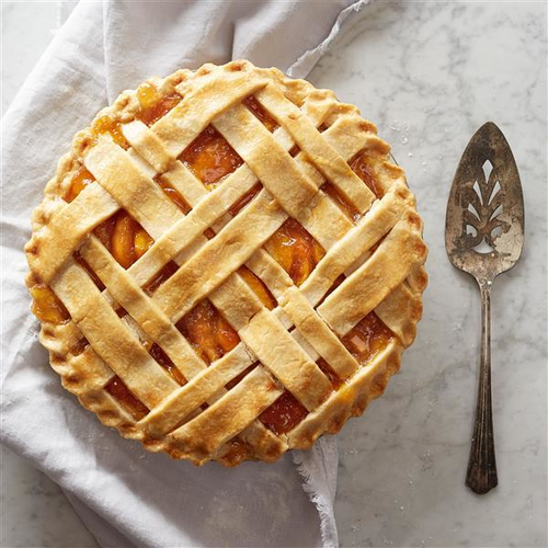 Final overhead shot of a perfectly baked Apple Pie with a Lattice Crust on a rustic wooden table, emphasizing the warmth, inviting comfort, and the essence of cozy farmhouse life.