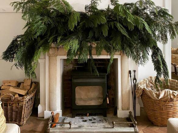 Candle and pinecone mantel arrangement