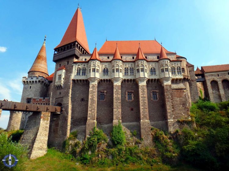 A panoramic view inside Turda Salt Mine, showcasing the vast underground chambers, illuminated walkways, and recreational activities, like boating on the underground lake.