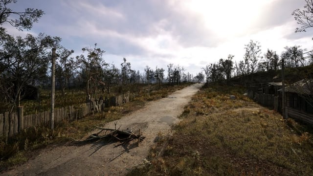 A Stalker, equipped with a gas mask and assault rifle, stands in the foreground against a backdrop of dilapidated buildings shrouded in mist and fog. The image captures the eerie and desolate atmosphere of the Chornobyl Exclusion Zone.