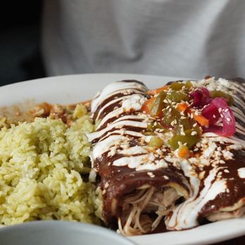 A close-up shot of mole poblano served on a plate.
