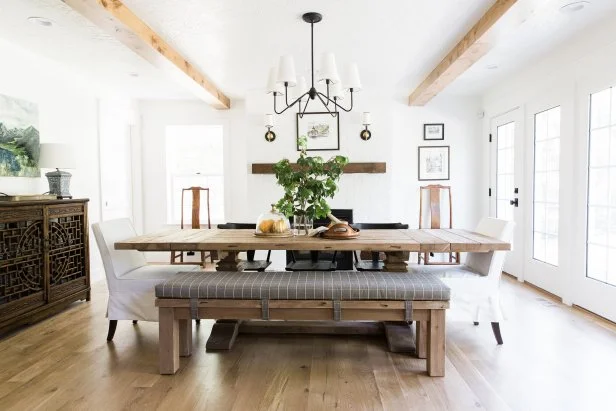 A kitchen featuring a breakfast nook, stone walls and hardwood flooring, with lots of natural light.
