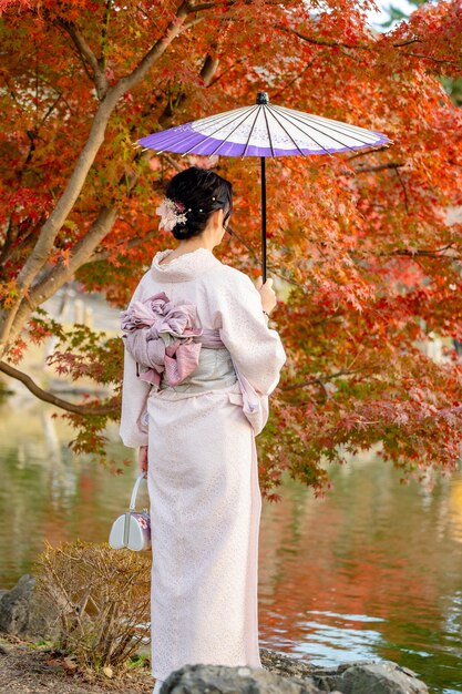 Sunlight filtering through the towering bamboo stalks in Arashiyama Bamboo Grove, creating patterns of light and shadow, emphasizing the serenity and beauty of the grove.