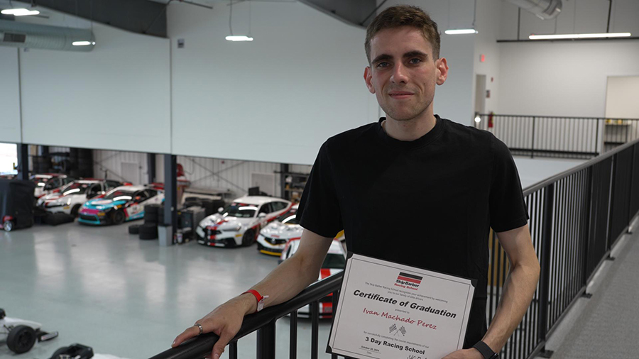An in-game screenshot from Elite Dangerous running on the simulated PC build, highlighting a detailed space station environment with realistic lighting and textures on the triple monitor setup.