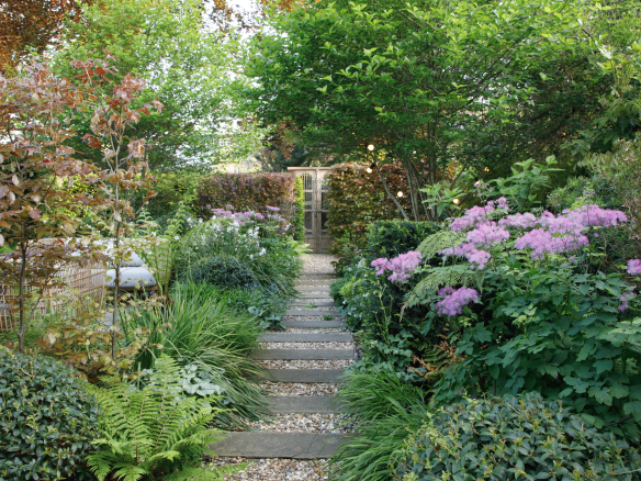 Two people working in a garden on a sunny day