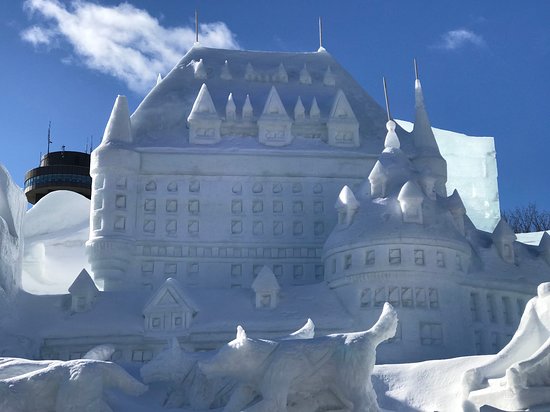A close-up of intricate snow sculpture details at the workshop, showcasing the artistry and skill of the participants. Capture the texture and light playing on the sculpted snow.