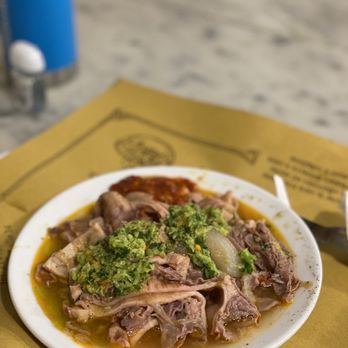 A close-up shot of a Lampredotto sandwich from Nerbone in Mercato Centrale, highlighting its texture and inviting appearance.