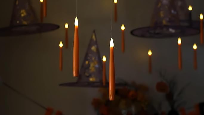 A pair of hands holding the completed Yule Beeswax Candle Centerpiece with a glowing light around the hands.