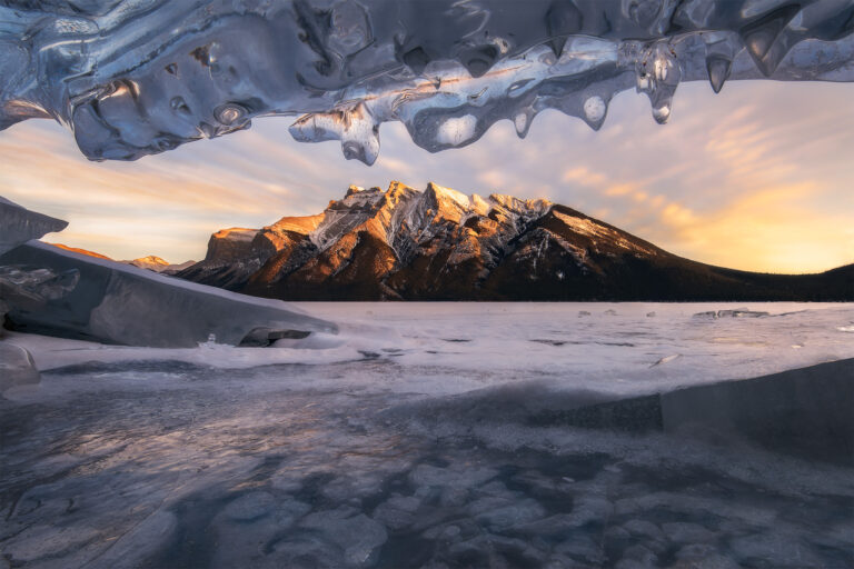 Turquoise ice bubbles at sunrise, reflections of the surrounding mountains in the ice. So grateful to experience this natural phenomenon with @YamnuskaMountainAdventures! #AbrahamLake #IceBubbles #CanadianRockies