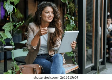 Cyclists riding along the coast with the turquoise coves in the background, wearing sunhats.