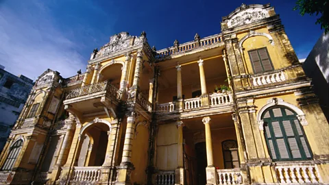 A wide boulevard in Phnom Penh with French colonial architecture and bustling street life
