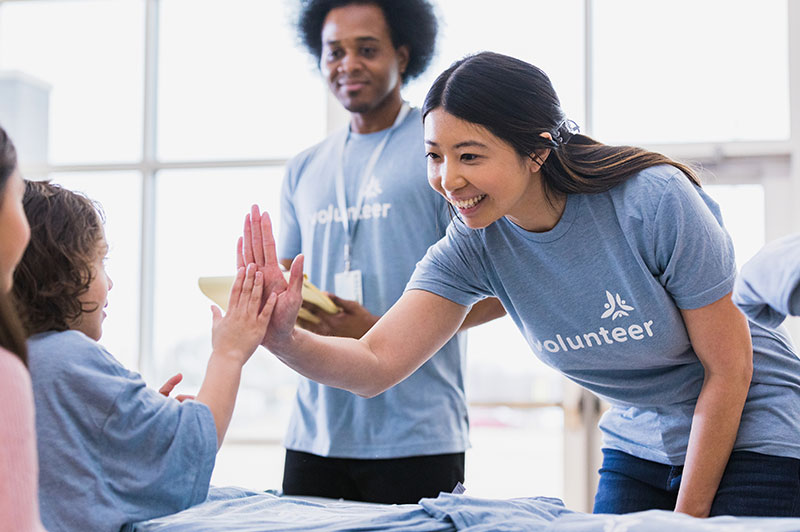 An infographic showcasing the impact of "Community Food Basket of Anytown." The graphic includes images of fresh produce, smiling families, and statistics on the number of people served.
