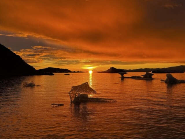Hikers crossing a river on the Laugavegur trail in Iceland.