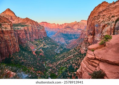 Canyoneering in Orderville Canyon, rappelling down a waterfall into a narrow slot canyon.