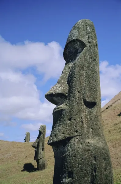 An image capturing the unfinished Moai statues scattered across the hillside of Rano Raraku quarry, showcasing the sensory experience and the overwhelming visual impact of the unfinished statues. The alt text contains rich description to help search engines associate this image with the topic