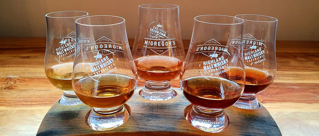 An elegant drawing room with a fireplace and portrait of Queen Victoria