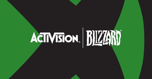 A photo of a person using a gaming controller in front of a monitor displaying a video game. The image focuses on the user's hands and the controller, highlighting the interaction between the gamer and the game.