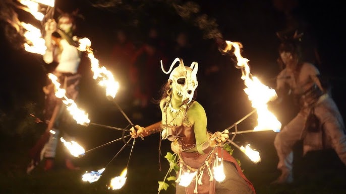 A group of performers in elaborate costumes and face paint participate in the Samhuinn Fire Festival in Edinburgh.