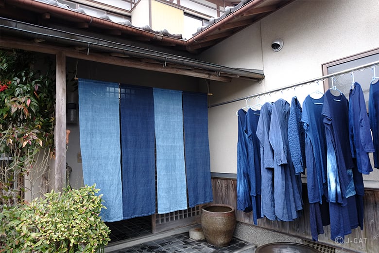 The Ace Hotel Kyoto exterior at dusk, with warm light spilling from the windows