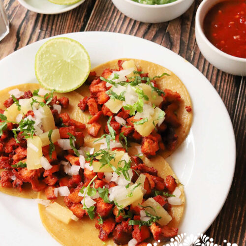 A screenshot of the Prompt Marketer platform, showcasing the AI generating Instagram captions from user reviews for Taco Fiesta, clean and intuitive interface, modern design, featuring the phrase 'Al Pastor Tacos' extracted from a review.