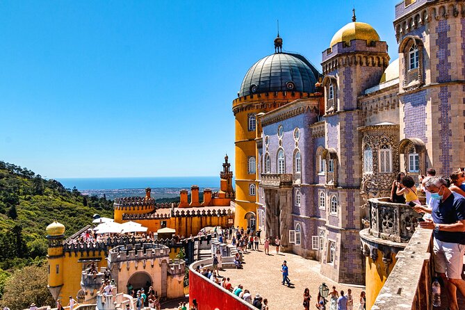 descriptive alt text: A close-up view of Pena Palace showcasing its vibrant colors and unique architecture, representing the primary attraction of Sintra