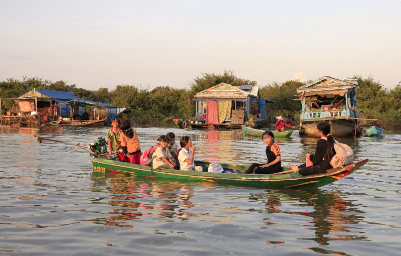 Anya helps local children fix a fishing net in Kampong Phluk