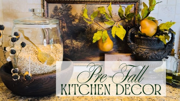 A vintage mason jar filled with autumn foliage and berries sits on a countertop, showcasing a thrifty and charming decorative element.