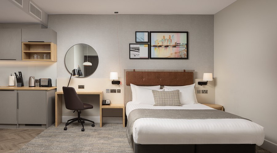 A photo of Maria and David using their binoculars to gaze at the night sky, silhouetted against the Milky Way.