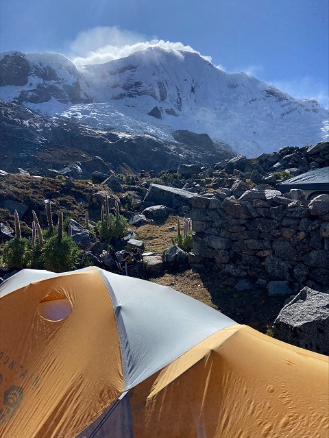 Mountain Hardwear Trango 2 tent pitched at Devils Garden Campground, showcasing its stability in the wind, with the red rock landscape in the background.