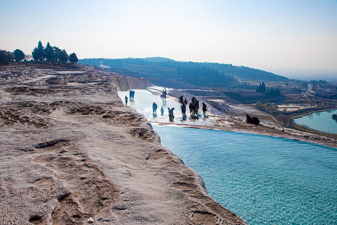 Pamukkale, Turkey: Shimmering white terraces cascading down the hillside, filled with turquoise thermal waters.