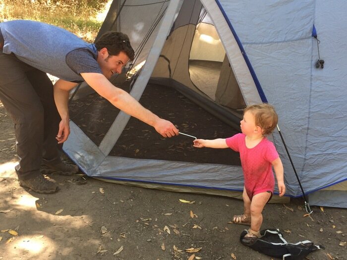 Toddler helping with tent