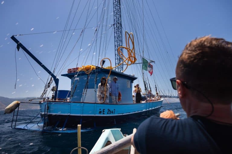 An icebreaker navigates through the icy waters of the Northwest Passage, with a vast, white landscape in the background.