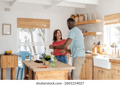 Diverse couple enjoying gardening together