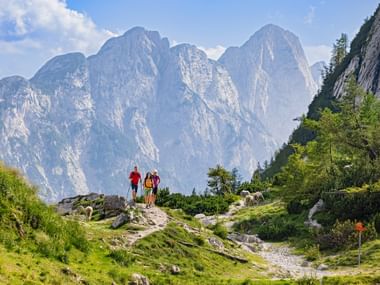 Hikers admiring the Vrsic Pass in the Julian Alps