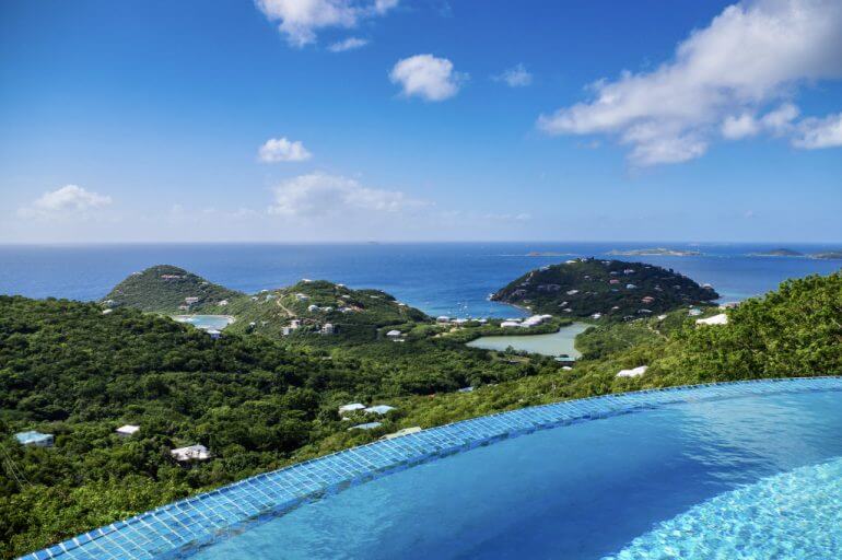 A manta ray gracefully swimming near the surface of the water, with sunlight filtering through the water creating a mesmerizing effect, emphasizing the beauty of marine life.