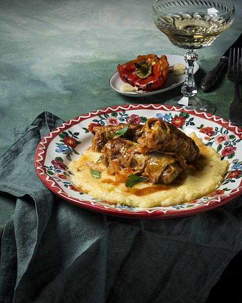 Corvin Castle illuminated in the blue hour, its gothic architecture shrouded in mist, highlighting its historical significance and rumored hauntings.
