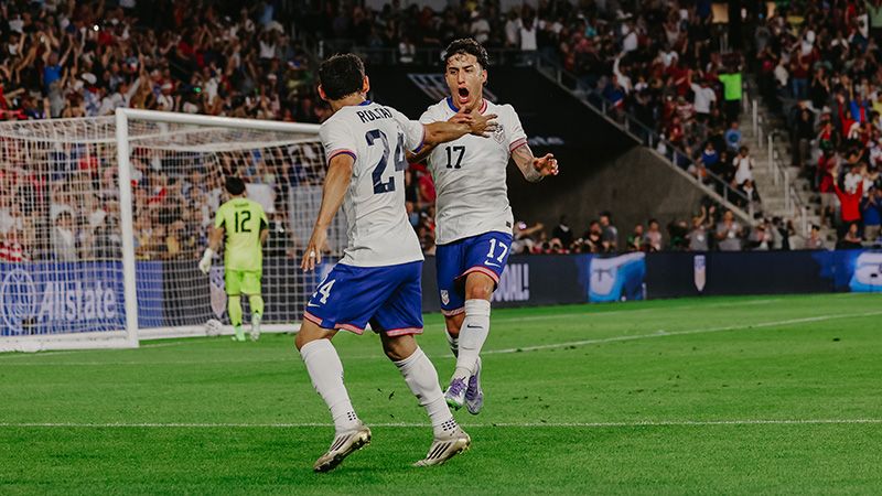 Players huddle around their IGL during a tactical timeout in a critical moment of a CS:GO match.